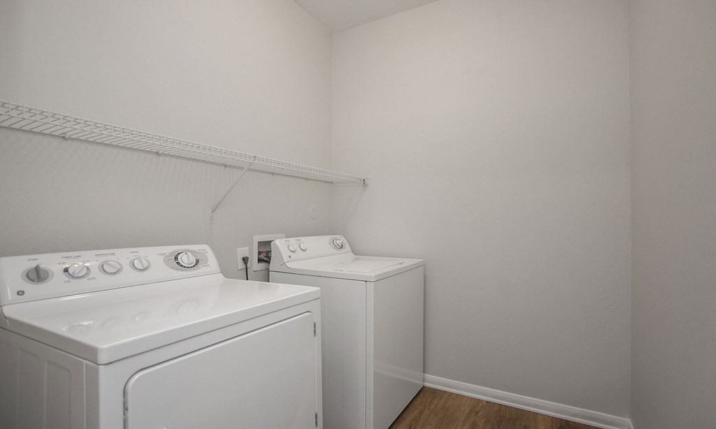 an empty laundry room with white appliances and a washer and dryer at Sladestone Shadow Creek, Pearland, TX, 77584