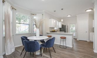 a kitchen and dining area with a table and chairs at Sladestone Shadow Creek, Texas