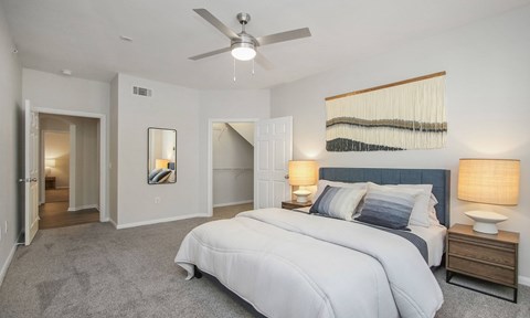 a bedroom with a large bed and a ceiling fan at Sladestone Shadow Creek, Pearland, TX