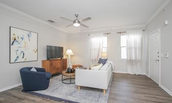 a living room with a ceiling fan and a couch at Sladestone Shadow Creek, Pearland, TX