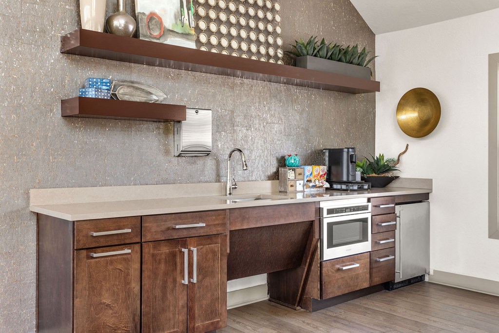 a kitchen with wooden cabinets and a sink and a stove at Arcadia Apartments, Centennial, CO 80112