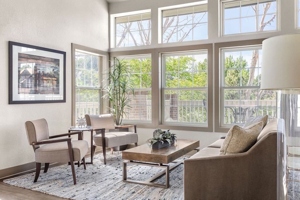 a living room with a couch and chairs and large windows at Arcadia Apartments, Colorado, 80112