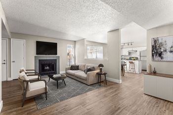 a living room with a couch and chairs and a fireplace at Arcadia Apartments, Centennial
