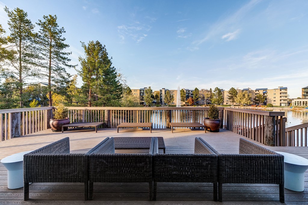 a deck with a fire pit and a view of the city at Ashford Belmar Apartments, Colorado