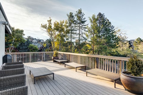 the deck has a view of the mountains and trees at Ashford Belmar Apartments, Lakewood