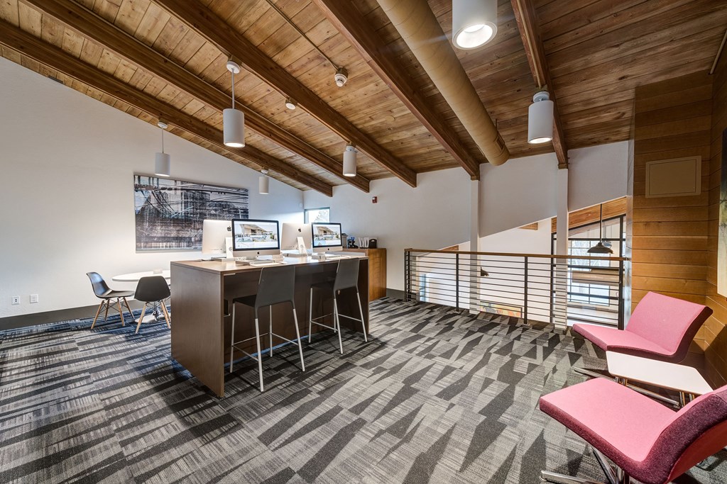an office space with a desk and chairs and a bar with chairs at Ashford Belmar Apartments, Colorado, 80226