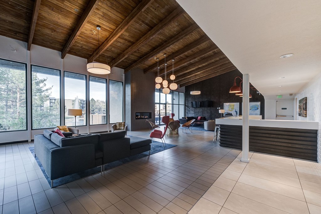 the living room and kitchen of a modern house with large windows at Ashford Belmar Apartments, Lakewood, 80226