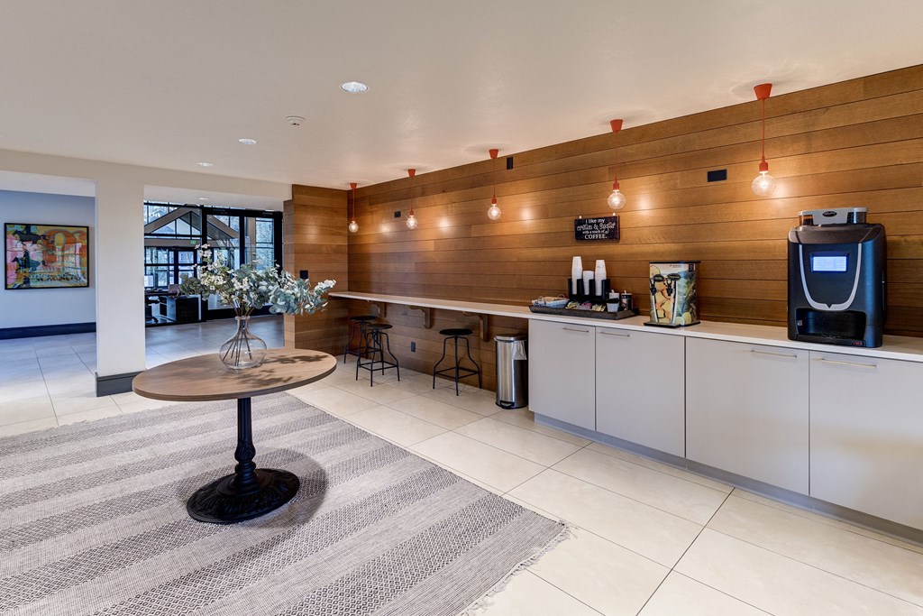a kitchen with a coffee table and a refrigerator at Ashford Belmar Apartments, Colorado
