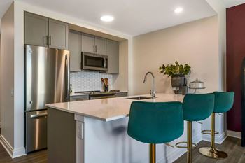 a kitchen with stainless steel appliances and a white counter top  at The Belden Stratford, Chicago, IL