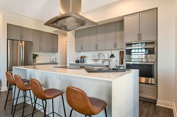 a kitchen with a large island with three chairs  at The Belden Stratford, Illinois