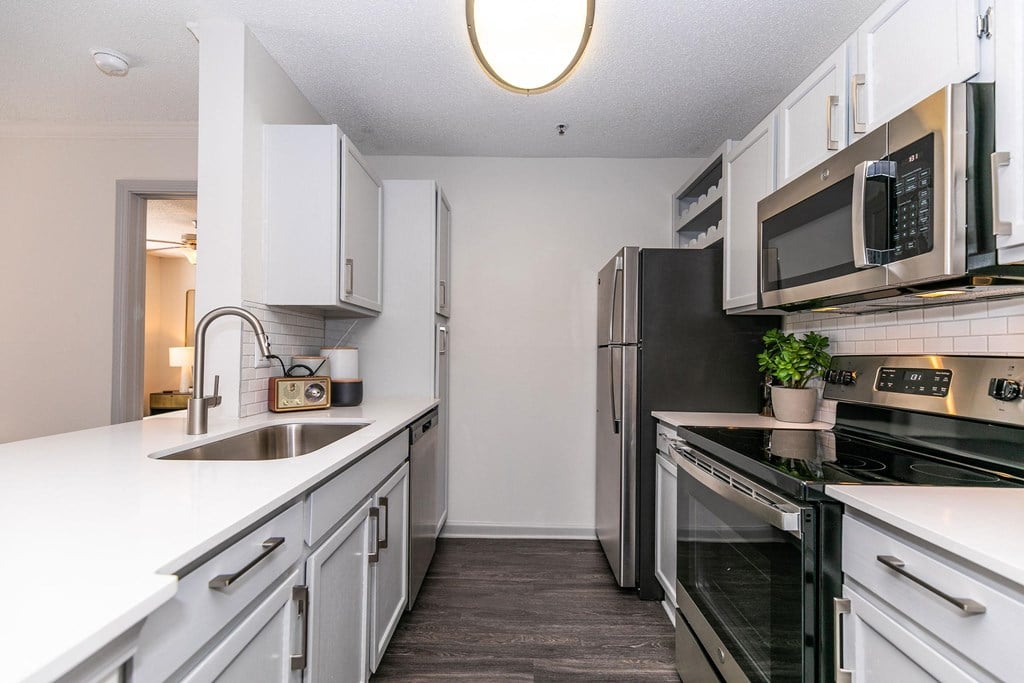 an empty kitchen with white cabinets and stainless steel appliances an empty kitchen with white cabinets and stainless steel appliances at Briarcliff Apartments, Atlanta, GA, 30329
