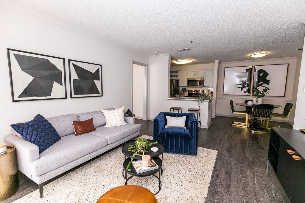 a living room with a couch and two chairs a living room with a couch and two chairs at Briarcliff Apartments, Atlanta