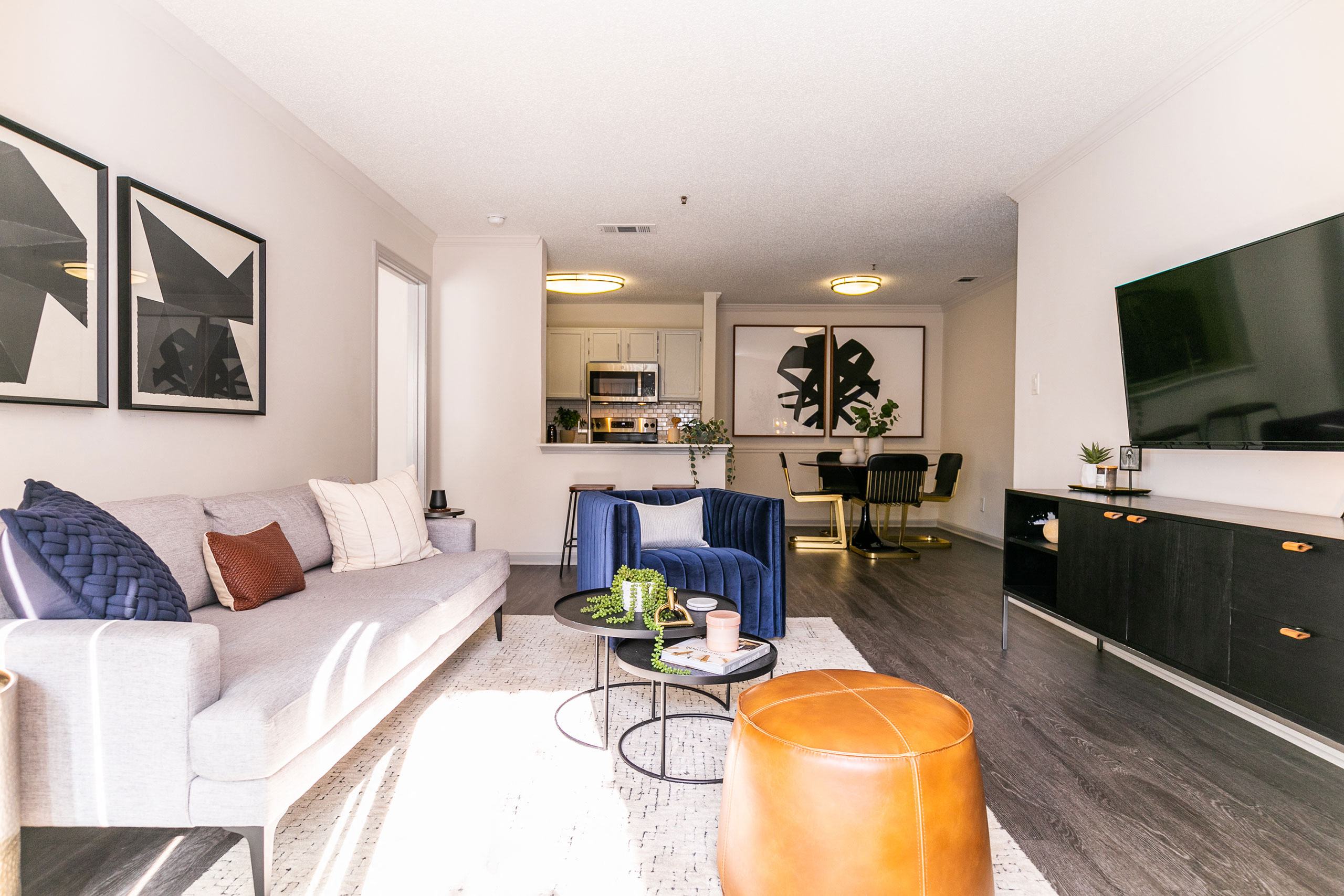 a living room with a white couch and a tv