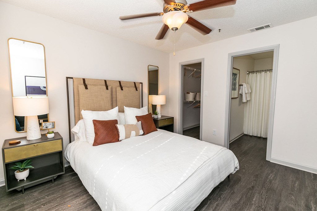 a bedroom with a large bed and a ceiling fan a bedroom with a large bed and a ceiling fan at Briarcliff Apartments, Atlanta