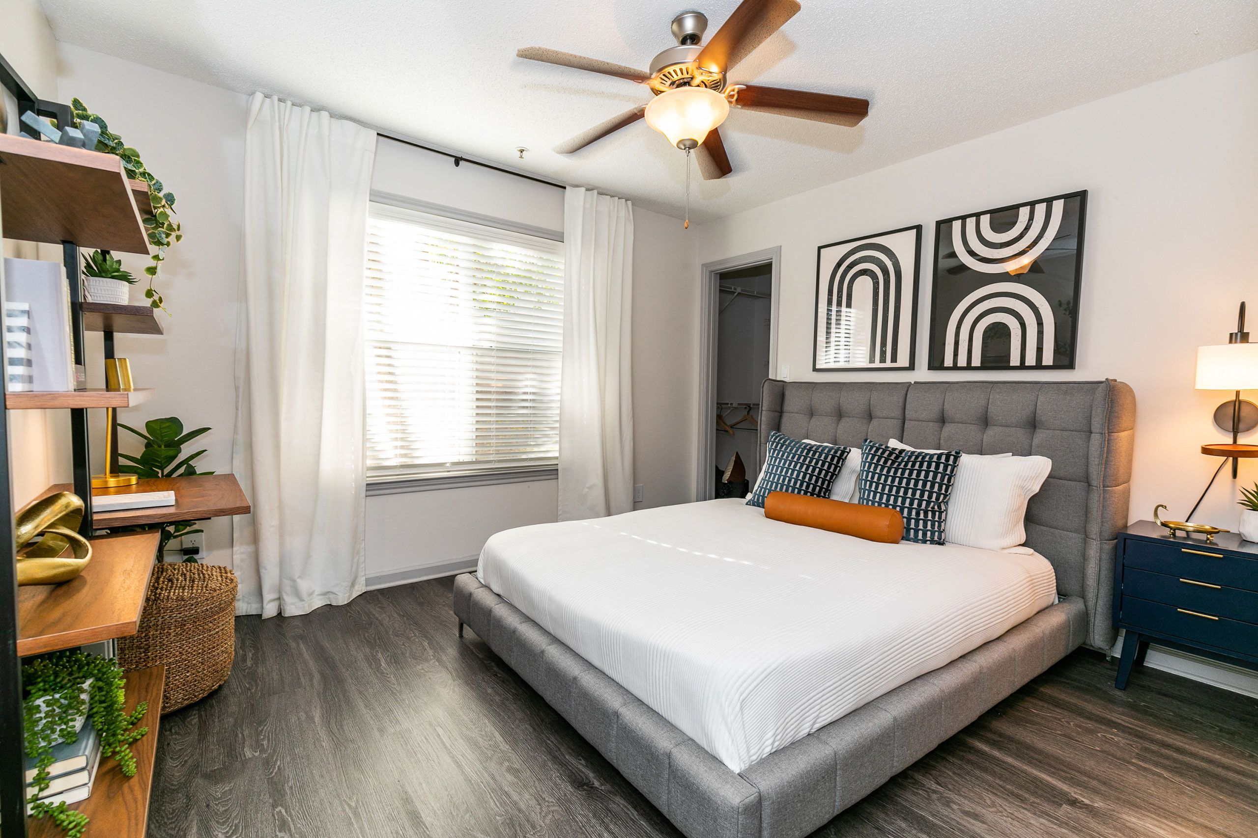 a bedroom with a large bed and a ceiling fan