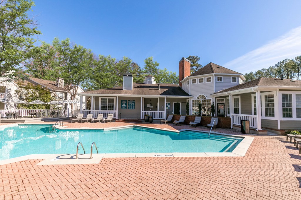 a large swimming pool with a house in the background a large swimming pool with a house in the background at Briarcliff Apartments, Georgia
