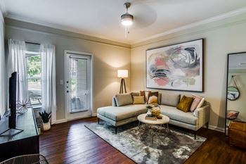 a living room with a couch and a table at Carrington at Barker Cypress, Cypress, TX, 77433