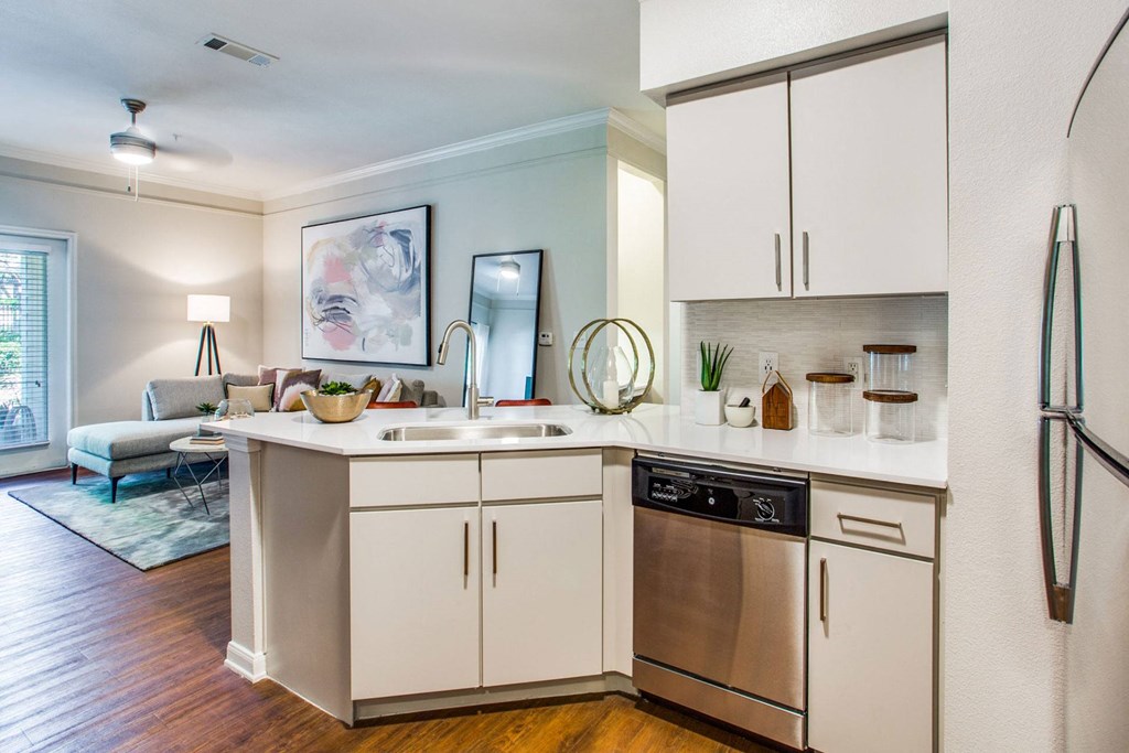 a kitchen with white cabinets and a sink and a dishwasher at Carrington at Barker Cypress, Cypress, TX, 77433