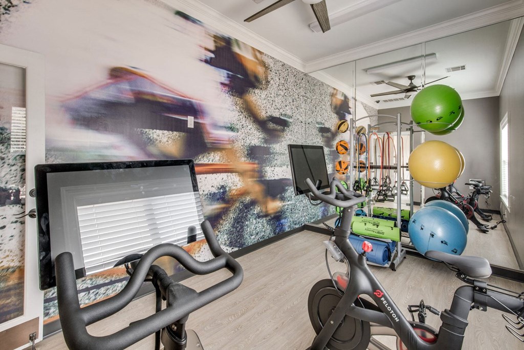 a home gym with exercise bikes and a computer at Carrington at Barker Cypress, Cypress, 77433