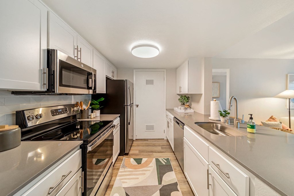 a kitchen with white cabinets and stainless steel appliances  at Citrine Hills, California, 91761