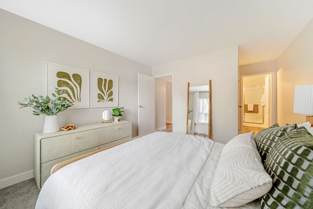 a bedroom with a large bed and a dresser with a plant on it  at Citrine Hills, California, 91761
