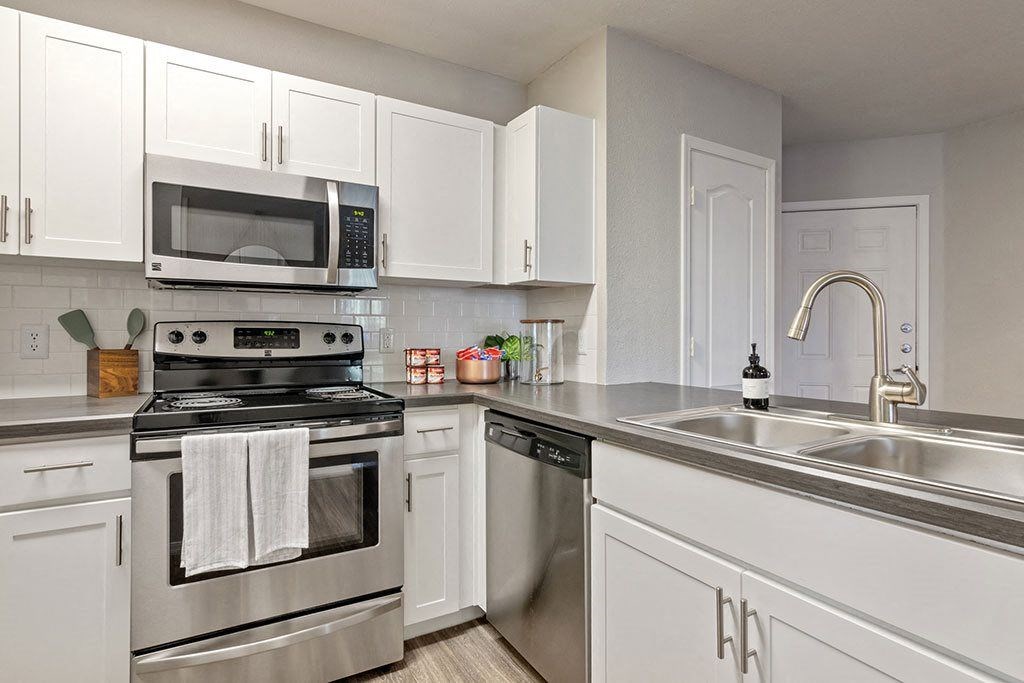 a kitchen with stainless steel appliances and white cabinets at Element Deer Valley, Arizona