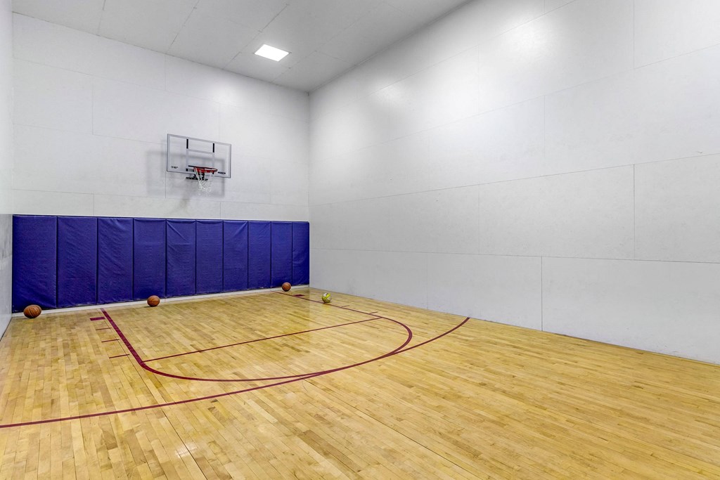 a basketball court in a gym with a wooden floor