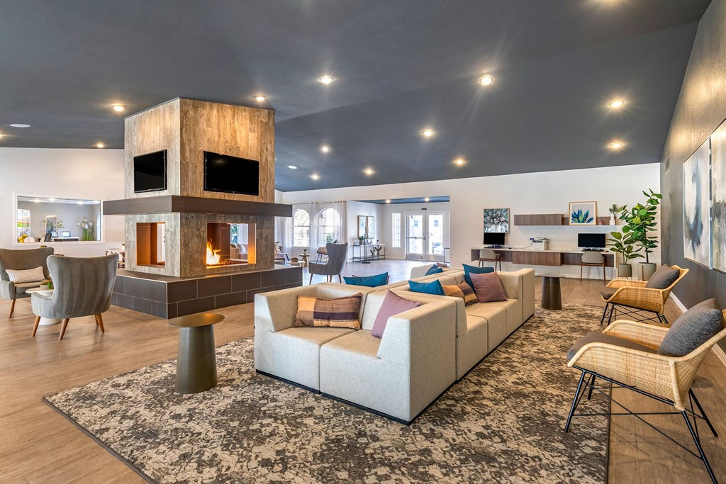 a living room with couches and chairs and a fireplace