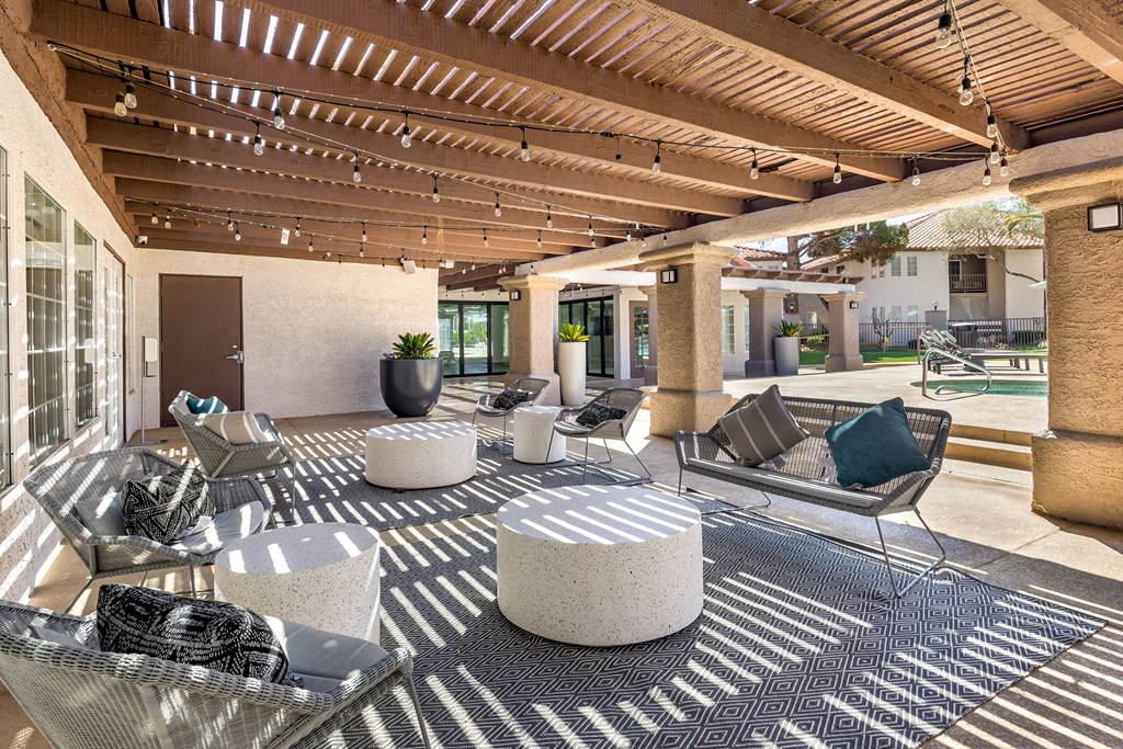 a patio with couches and tables and chairs