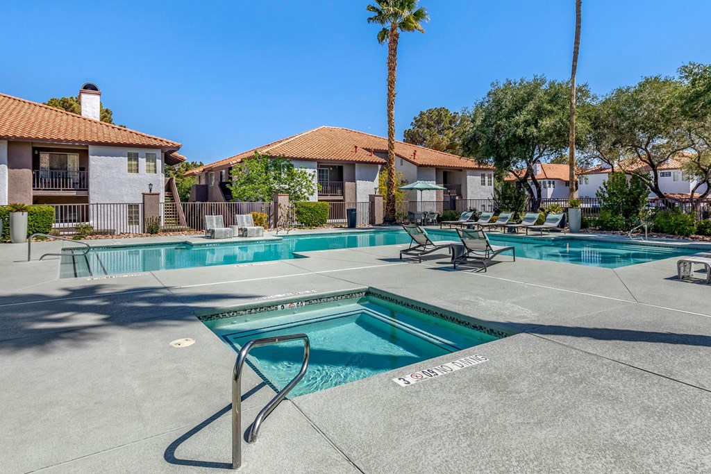our apartments have a resort style pool with lounge chairs and trees