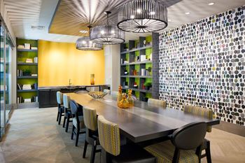 a dining room with a long table and yellow chairs at Heights at Glen Mills, Glen Mills Pennsylvania