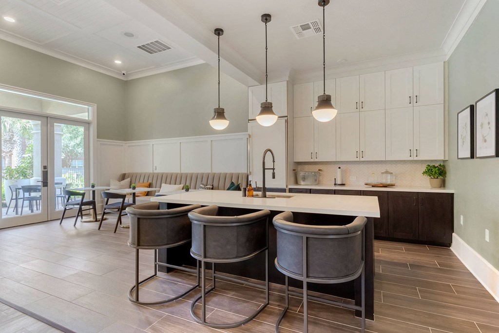a kitchen with a large island with bar stools at Madison on the Meadow, Stafford, TX