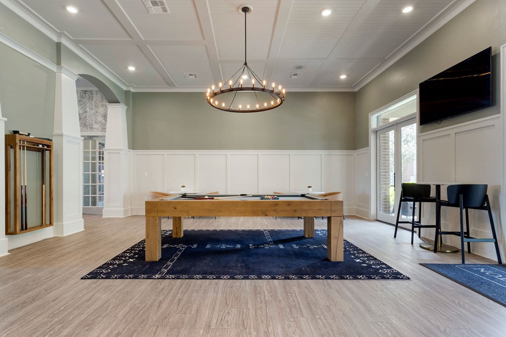 a game room with a pool table and a tv at Madison on the Meadow, Stafford, TX