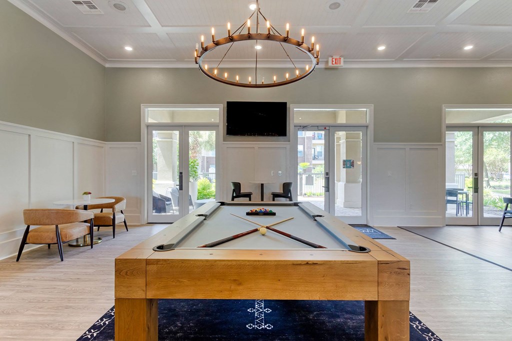 Resident Lounge with Pool Table and Ring Shaped Chandelier  at Madison on the Meadow, Stafford, TX, 77477