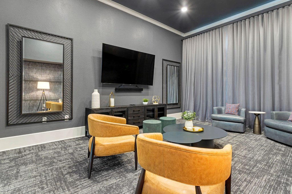 a living room with a tv and a table and chairs at Madison on the Meadow, Stafford, TX, 77477