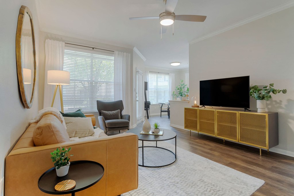 a living room with a couch and a tv at Madison on the Meadow, Stafford