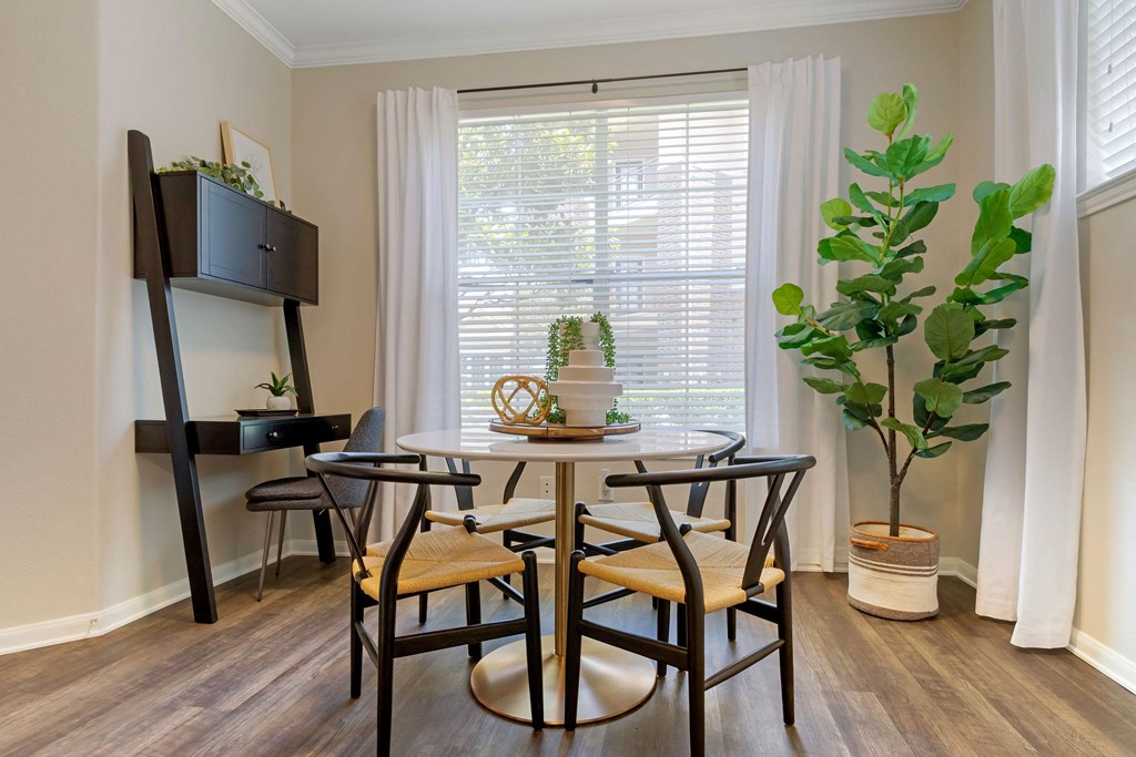a dining room with a table and chairs and a window at Madison on the Meadow, Texas