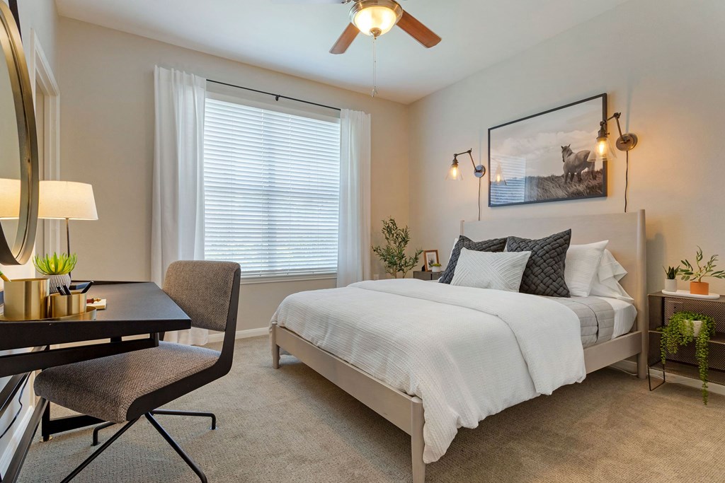 a bedroom with a bed and a desk and a window at Madison on the Meadow, Stafford, 77477