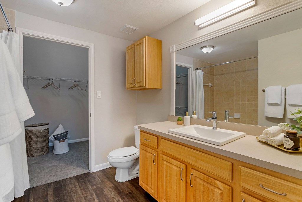 a bathroom with a toilet and a sink and a mirror at Madison on the Meadow, Stafford