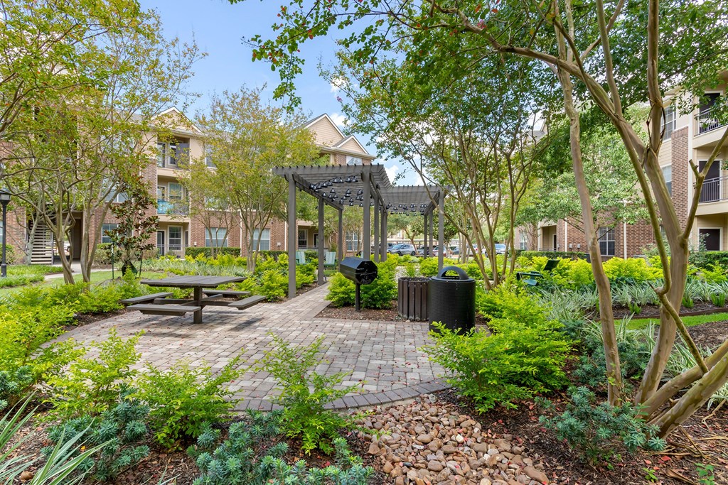 a picnic area with a picnic table and a gazebo in a park at Madison on the Meadow, Stafford