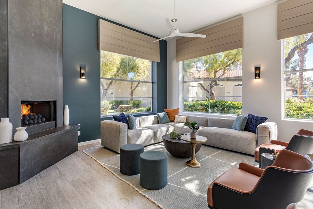 a living room with couches and chairs and a fireplace at Mirasol Apartments, Las Vegas, 89119