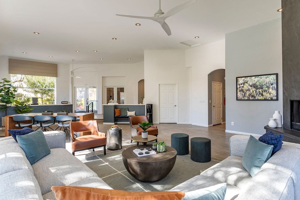 a living room with couches and chairs and a fireplace at Mirasol Apartments, Nevada