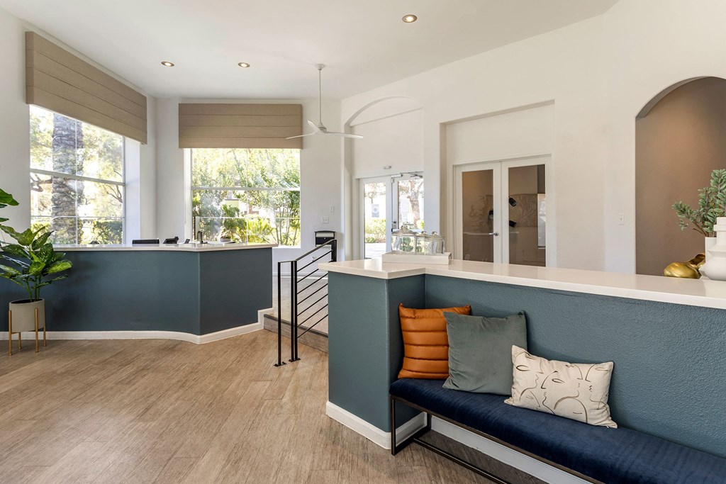 a kitchen and living room with a blue couch and a counter at Mirasol Apartments, Las Vegas, Nevada