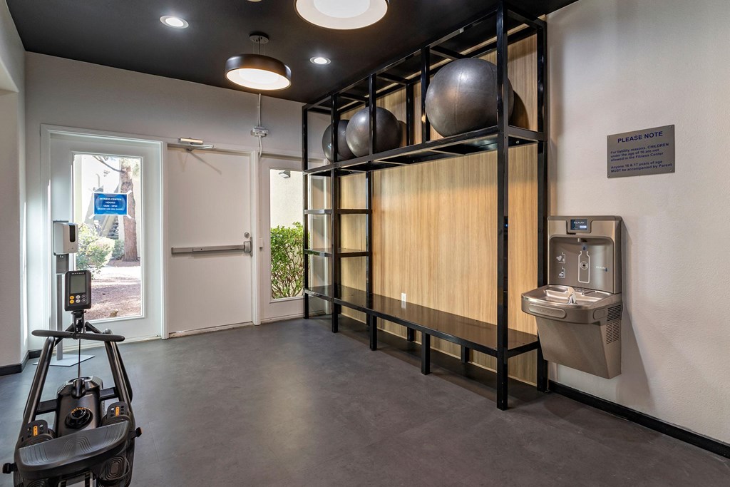 a gym with a projector screen and a sink in the corner of a room at Mirasol Apartments, Nevada, 89119