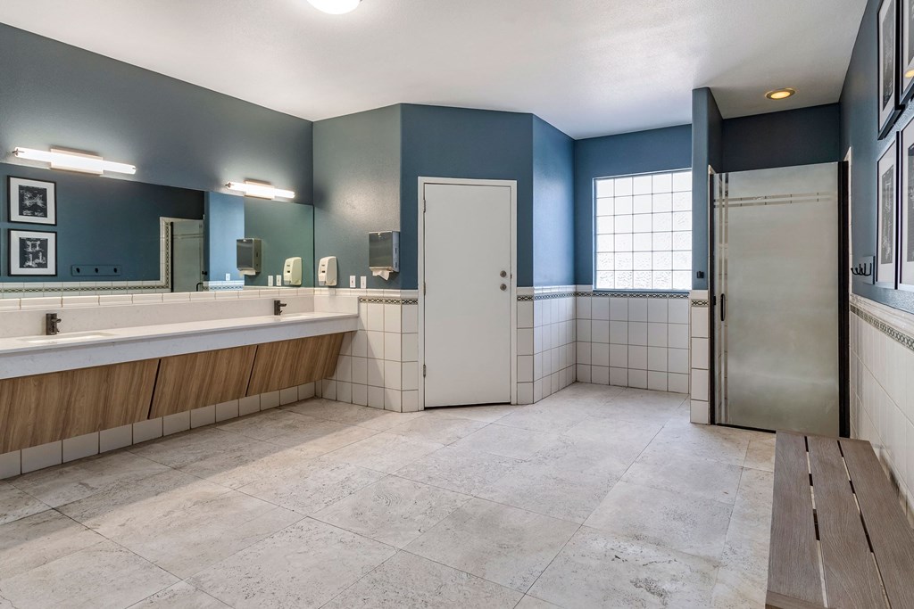 a large bathroom with a tub and a sink and a door at Mirasol Apartments, Las Vegas