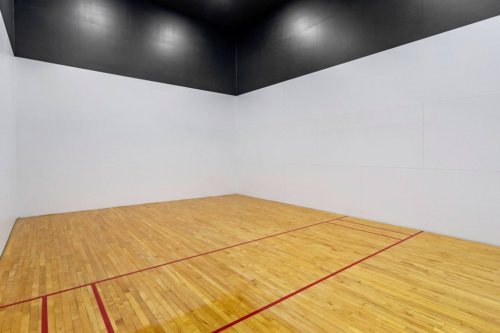 an empty gym with a racquetball court and a wooden floor at Mirasol Apartments, Las Vegas, 89119