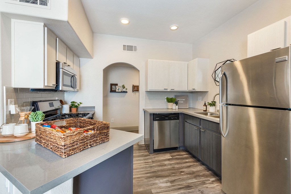 a kitchen with stainless steel appliances and a counter top with a basket at Mirasol Apartments, Las Vegas, NV 89119