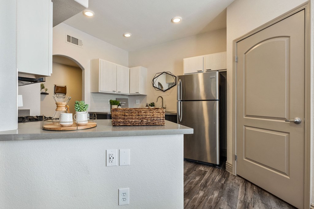 a kitchen with a counter top and a stainless steel refrigerator at Mirasol Apartments, Las Vegas, NV