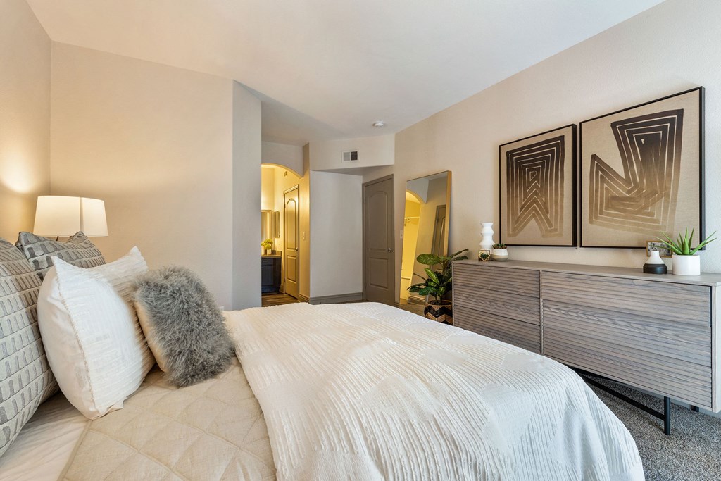 a bedroom with a large bed and a dresser at Mirasol Apartments, Las Vegas, Nevada