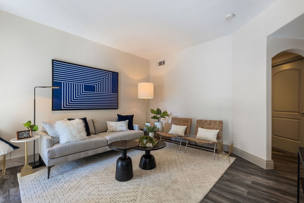a living room with a couch and chairs and a rug at Mirasol Apartments, Nevada